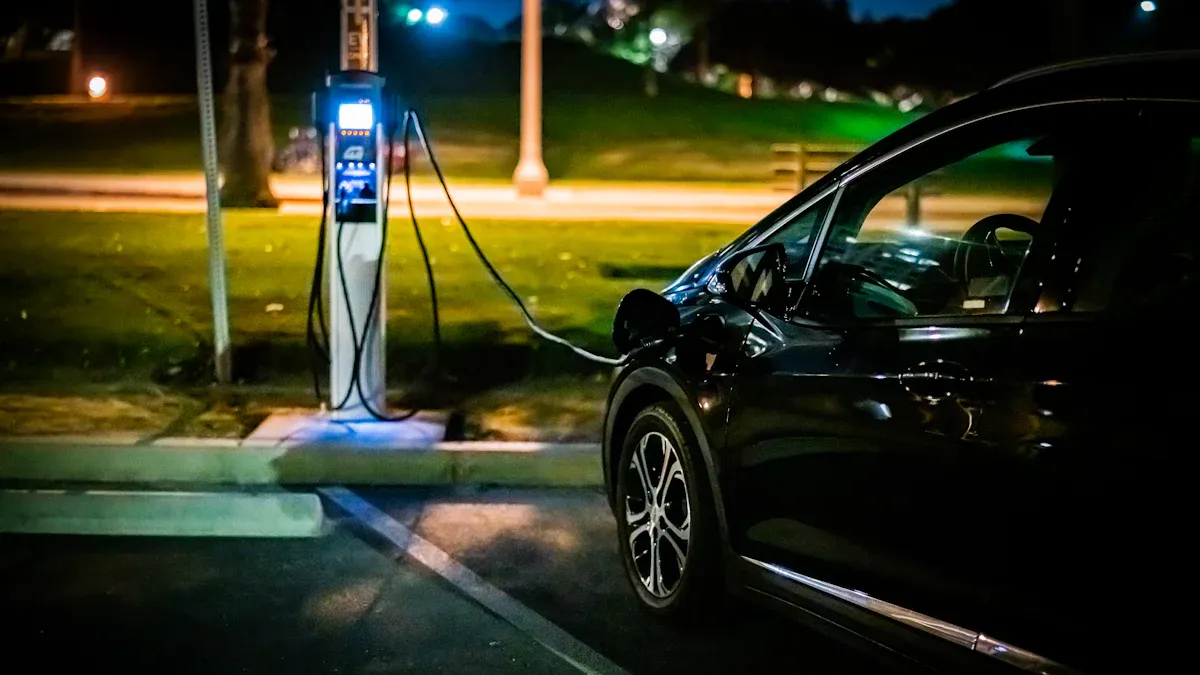 A car plugged into an outdoor public charging station at night. 